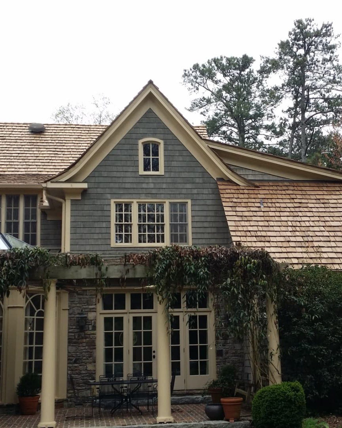 Shingle-sided estate with new cedar shake roof by Vest Construction